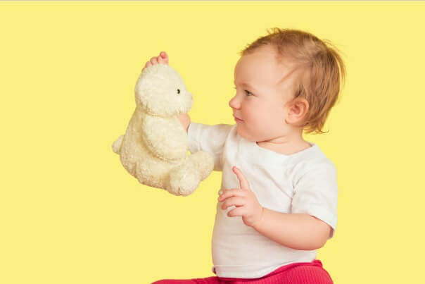 Teddy Bear. Baby holding Teddy Bear